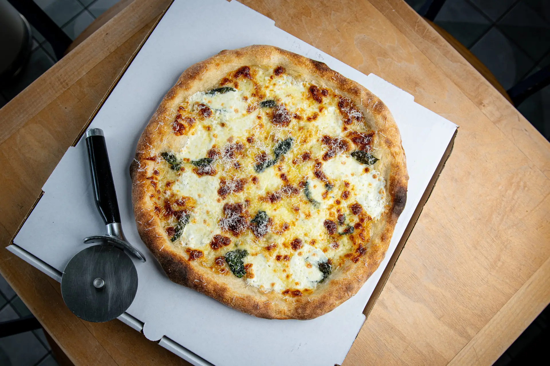 White sourdough pizza in a takeout box